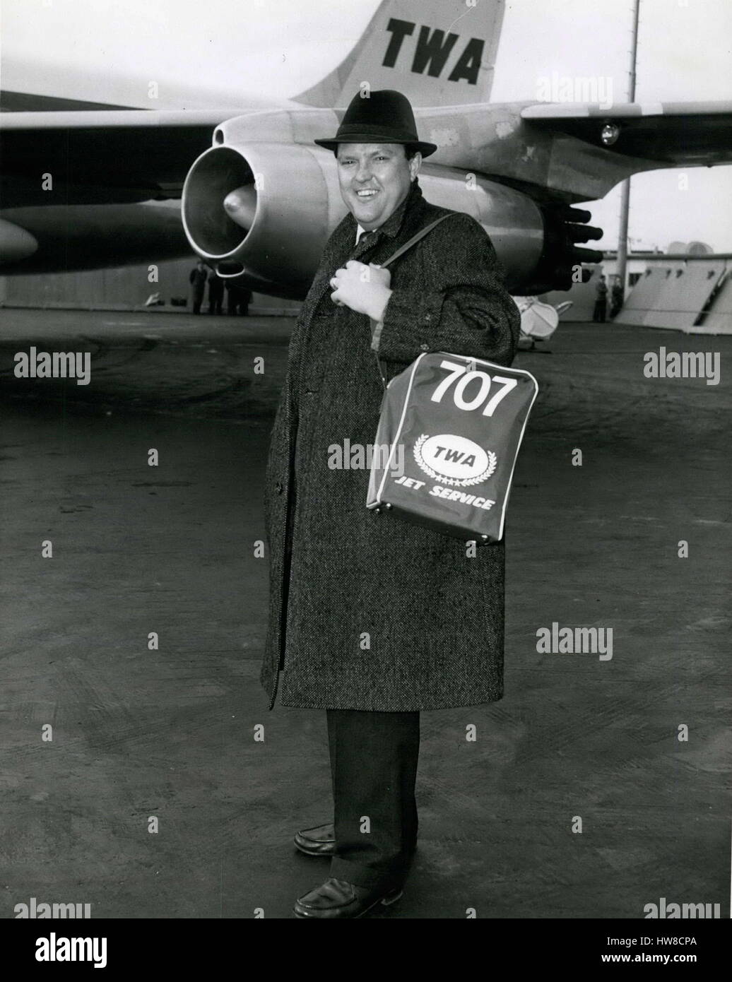 1962 - TWA's jet service to San Francisco started coincidently just in time to transport operatic Baritone Cornell MacNeil. Who has been singing in California with the cosmolitan opera, for an unexpected Metropolitan opera debut last night replacing Robert Merrill who is ill, and is seen here today prior to boarding TWA's JetLiner back again to San Francisco. The Cliffside park, N.J. sensation made a triumphant debut at La Scala on March 5 and has been following such a tight schedule that in his two brief stops through New York he hasn't had time to see his five children. The 34-year old forme Stock Photo