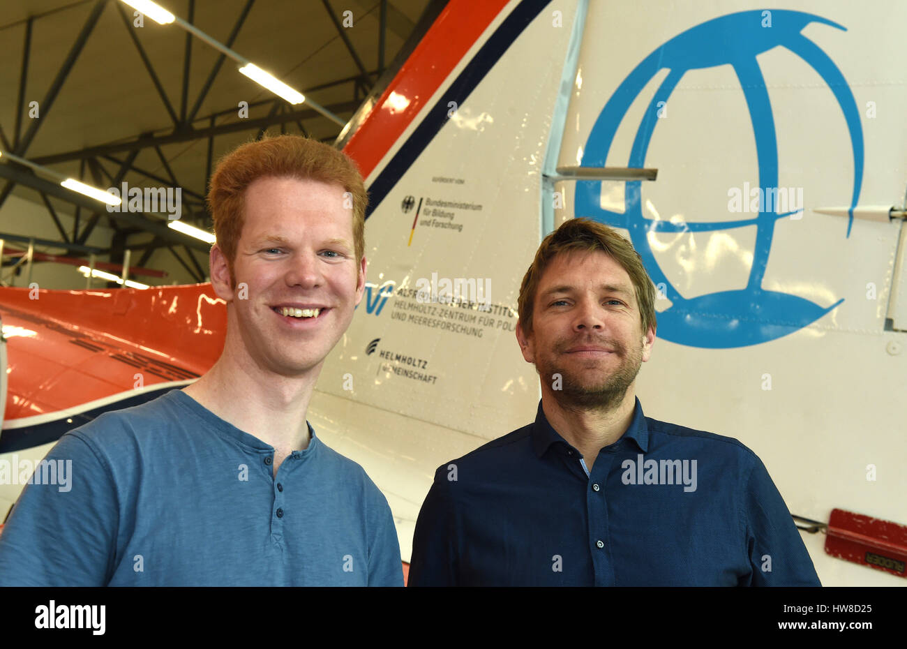 Bremen, Germany. 07th Mar, 2017. Tobias Binder (l) und Olaf Eisen from the  Alfred Wegener Institute (AWI) standing in front of the 'Polar 5' aircraft  in the hanger at the airport in