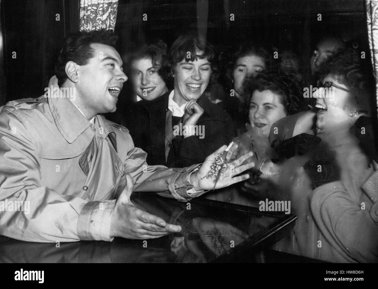 Nov. 15, 1957 - 15-11-57 Girl fans mob Mario Lanza when he arrives in London Ã¢â‚¬' Screaming fans broke down platform barriers and fought with police to mob Mario Lanza when he arrived at Victoria Station last night. In the mad heaving rush, their idol was knocked down, but he picked himself up smiling. The Hollywood star is here to sing at the Royal Variety Show on Monday and to appear on TV on Sunday. Photo Shows: Hero worship is displayed on the faces of these girls as he sings to them from the carriage of the train on his arrival at Victoria Station last night. (Credit Image: © Keystone Stock Photo