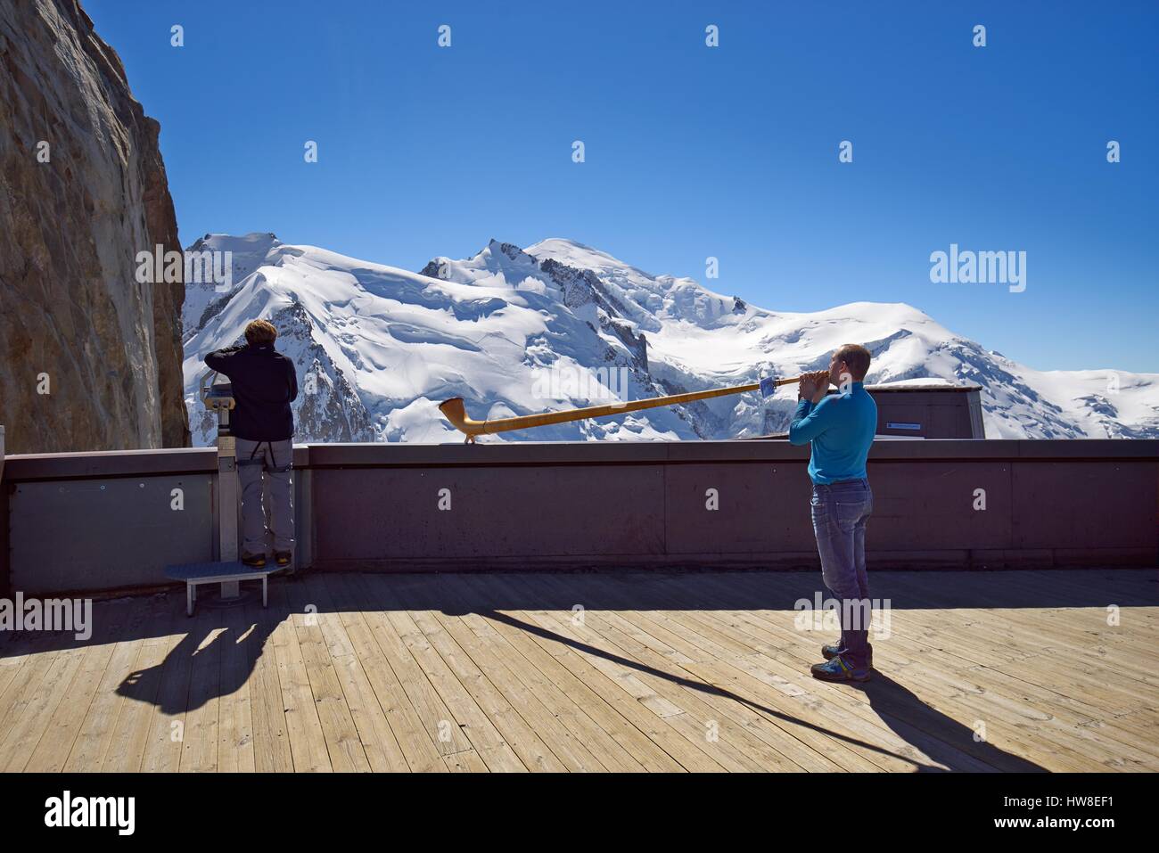 France, Haute-Savoie, Chamonix, Alpenhorn player on the top of aiguille du Midi (3848 m), Mont-Blanc range Stock Photo
