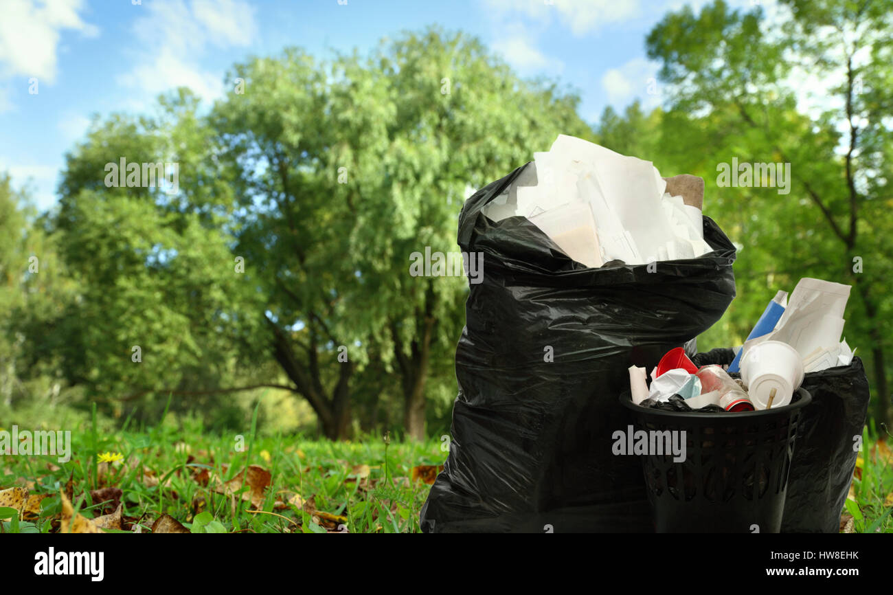 Full black wastebasket and plastic bags outside Stock Photo Alamy