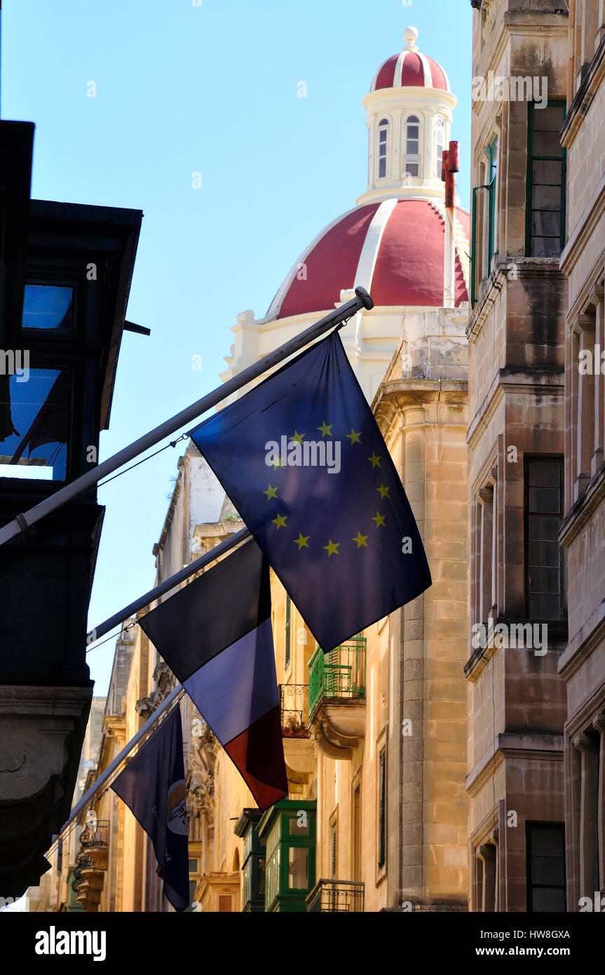 street in Valletta, Malta, with various flags Stock Photo