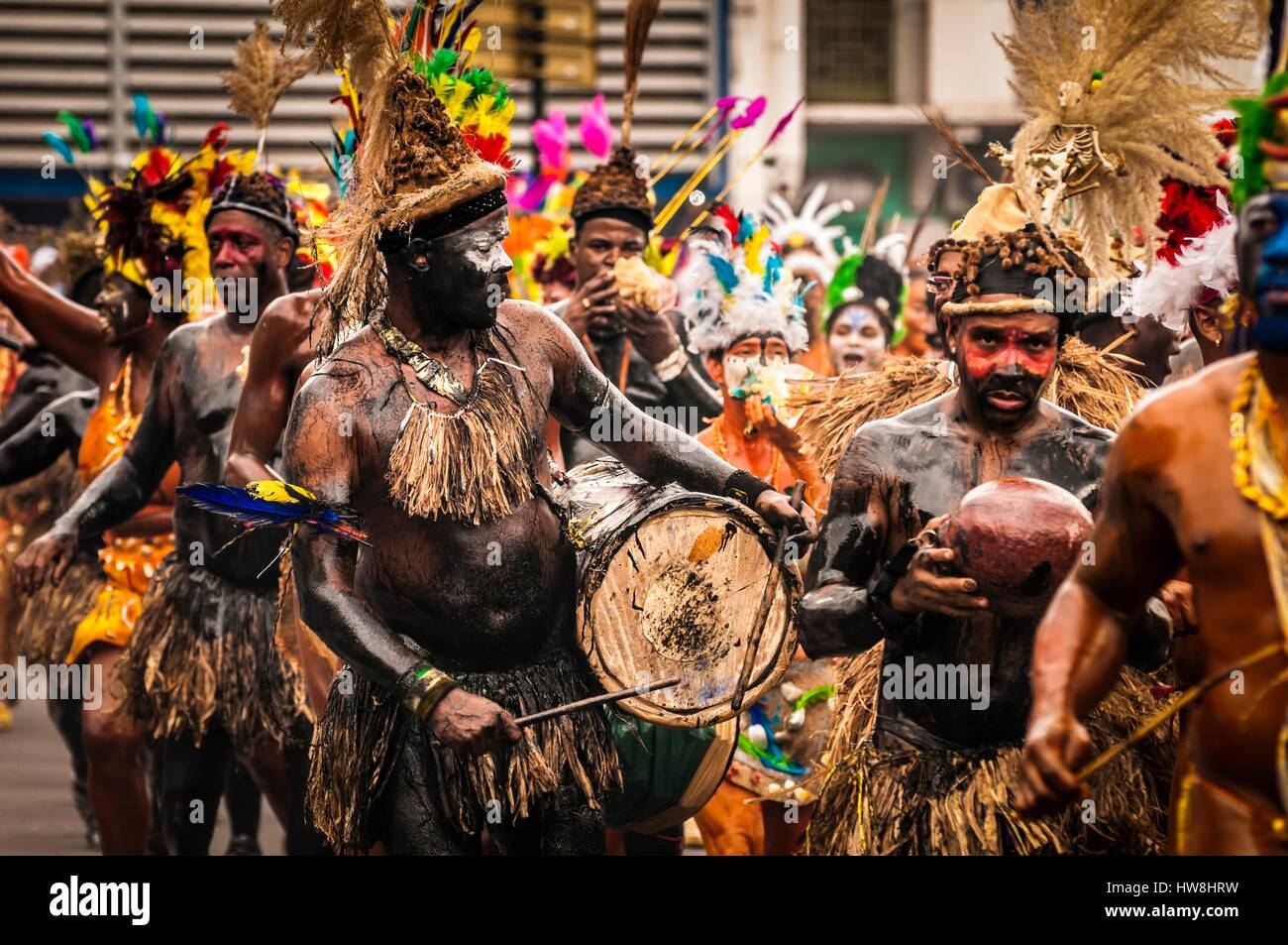 France, Guadeloupe, Basse Terre, musicians with battery syrup coated body,  from a Gwoup a Po, group of traditional percussion instruments, handcrafted  drums goatskin, Queen conch and chachas, during the closing parade of