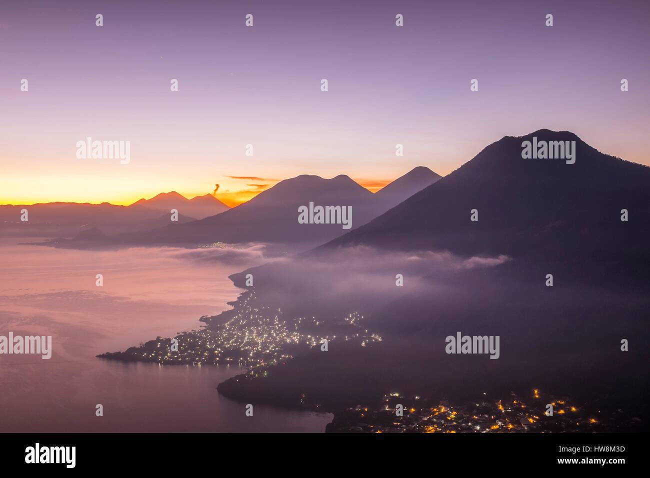 Guatemala, Solola department, San Juan la Laguna on the southern shore of Lake Atitlan, sunrise from Cerro Rupalaj Kistalin or Rostro Maya, the highest point of view of Lake Atitlan, San Pedro volcano in the foreground and Pacaya active volcano in the background Stock Photo