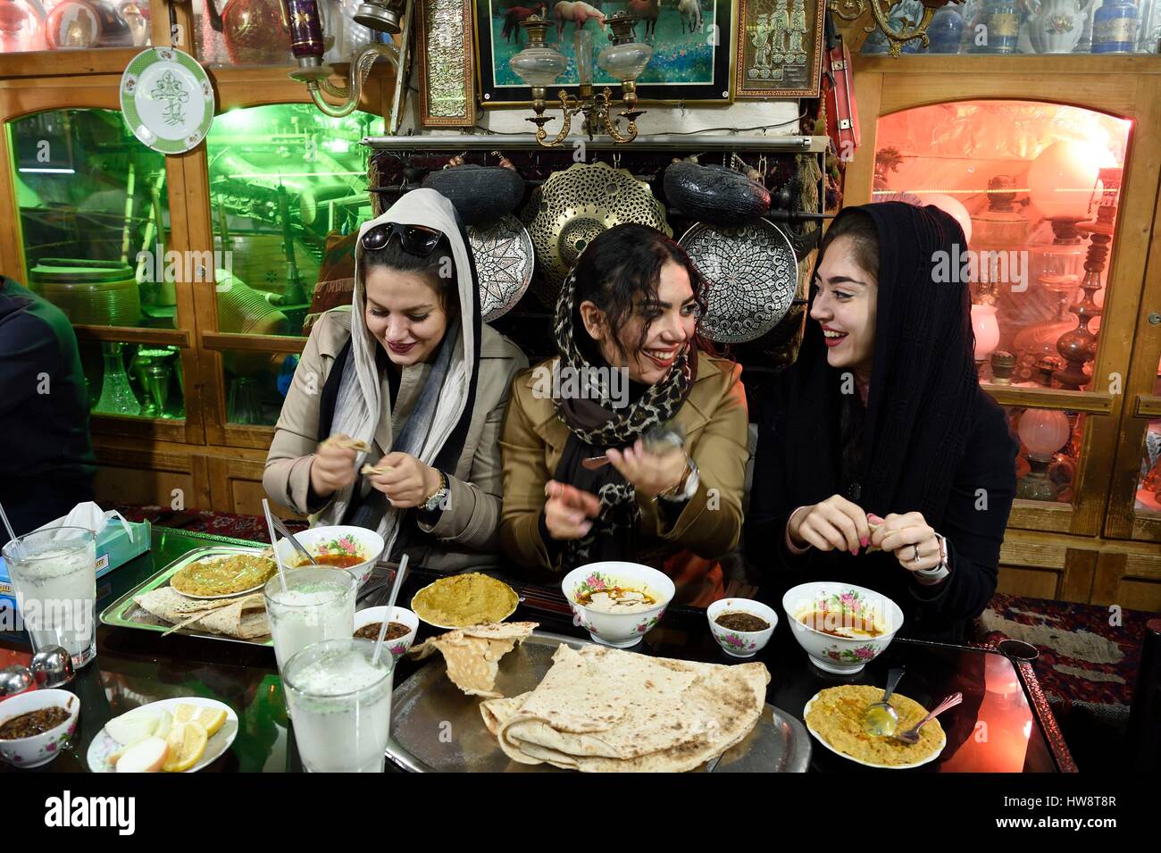 Iran, Isfahan Province, Isfahan, Chai Khaneh Azadegan Tea House and restaurant, young iranian women student in medical engineering whose name are, from left to right, Pita, Nadia and Niloufar (no model release) Stock Photo