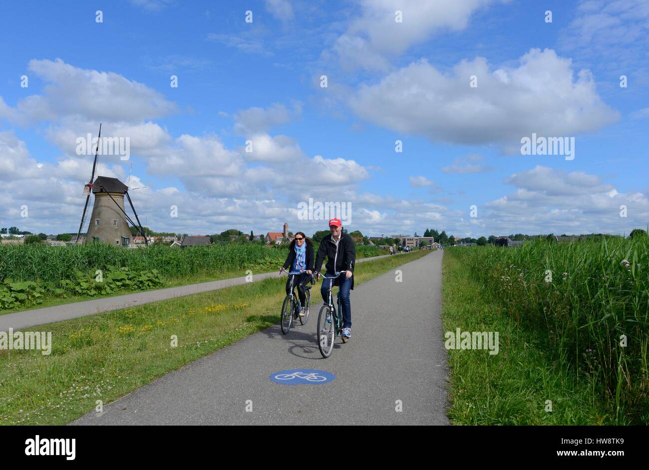 Netherlands, Holland, Kinderdijk windmills, bike ride along the 19 drainage mills of Kinderdijk listed as World Heritage by UNESCO Stock Photo