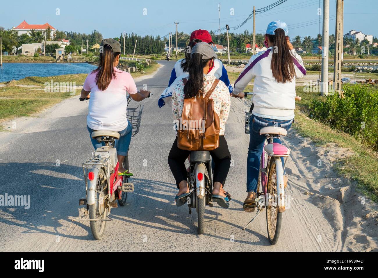 Vietnam, Khanh Hoa province, near Nha Trang, Doc Let, schoolgirls cycling Stock Photo