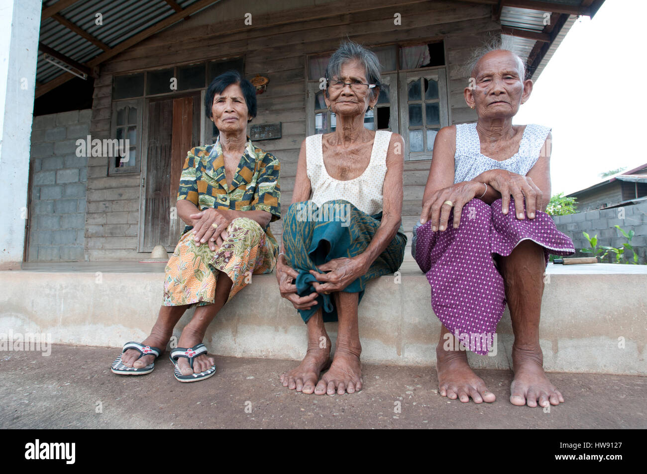 Thailand-may 28. Traditional village in North Thailand with three woman in front of there houses 28-05-11 Stock Photo