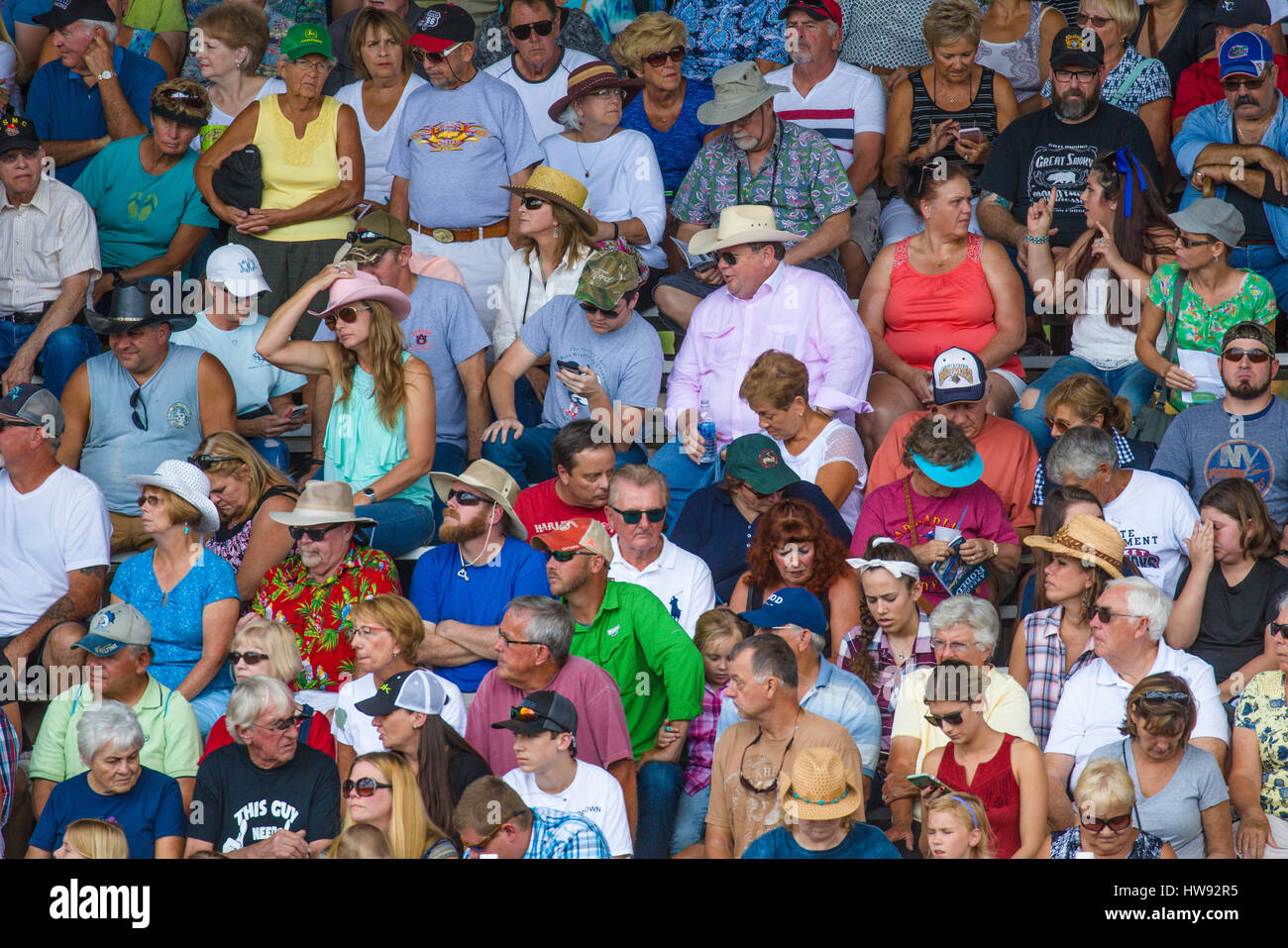 Crowd of people in bleachers at spectator sporting event Stock Photo