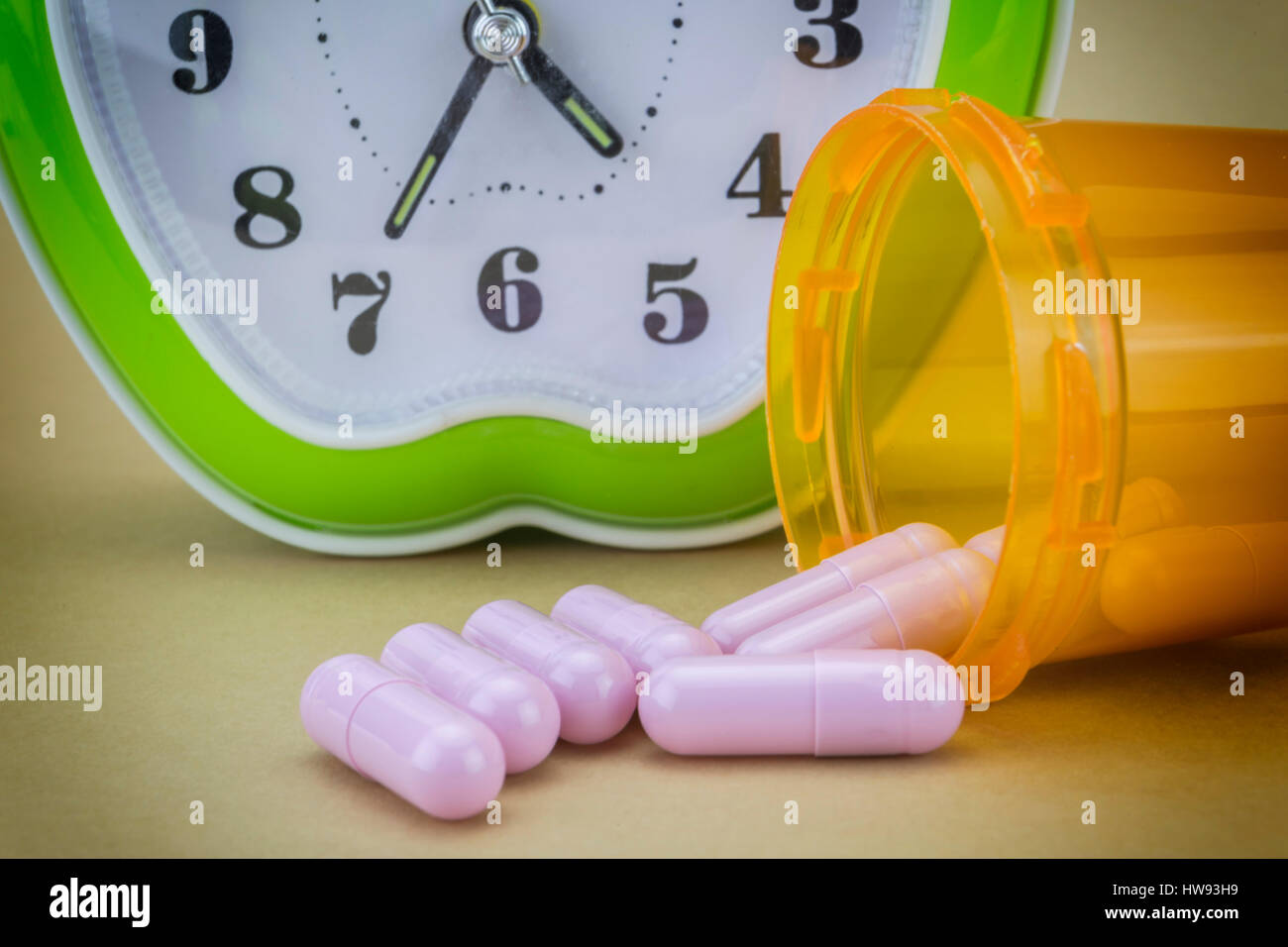 concept for Healthcare And Medicine, a green clock marks the time of taking medicines Stock Photo