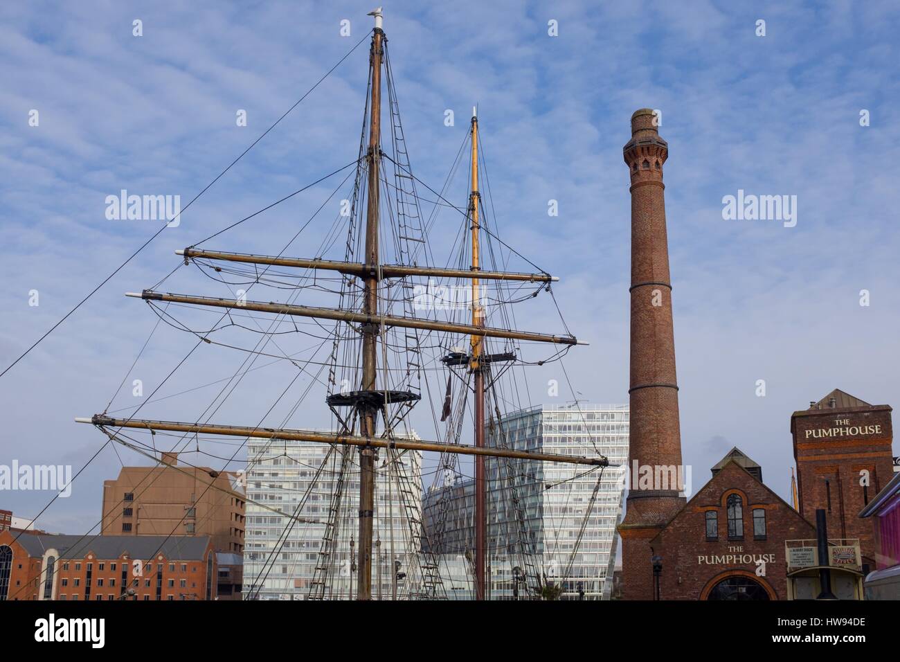 Pumphouse and tall boat mast against modern office blocks in Liverpool Stock Photo