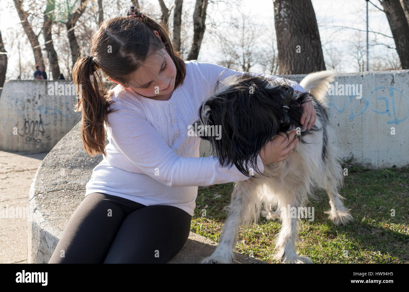 Little girl with dog in park Stock Photo - Alamy