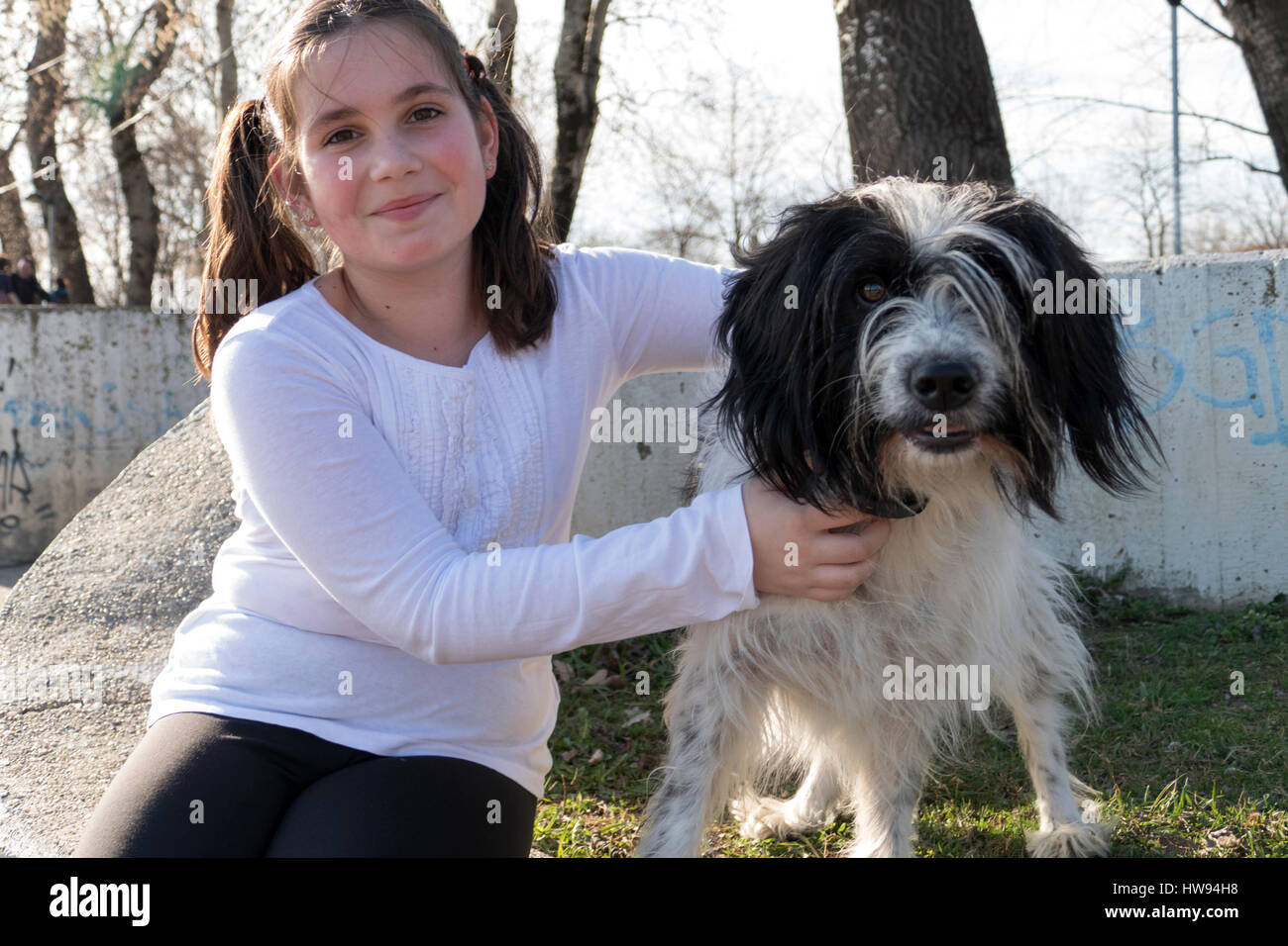 Little girl with dog in park Stock Photo - Alamy