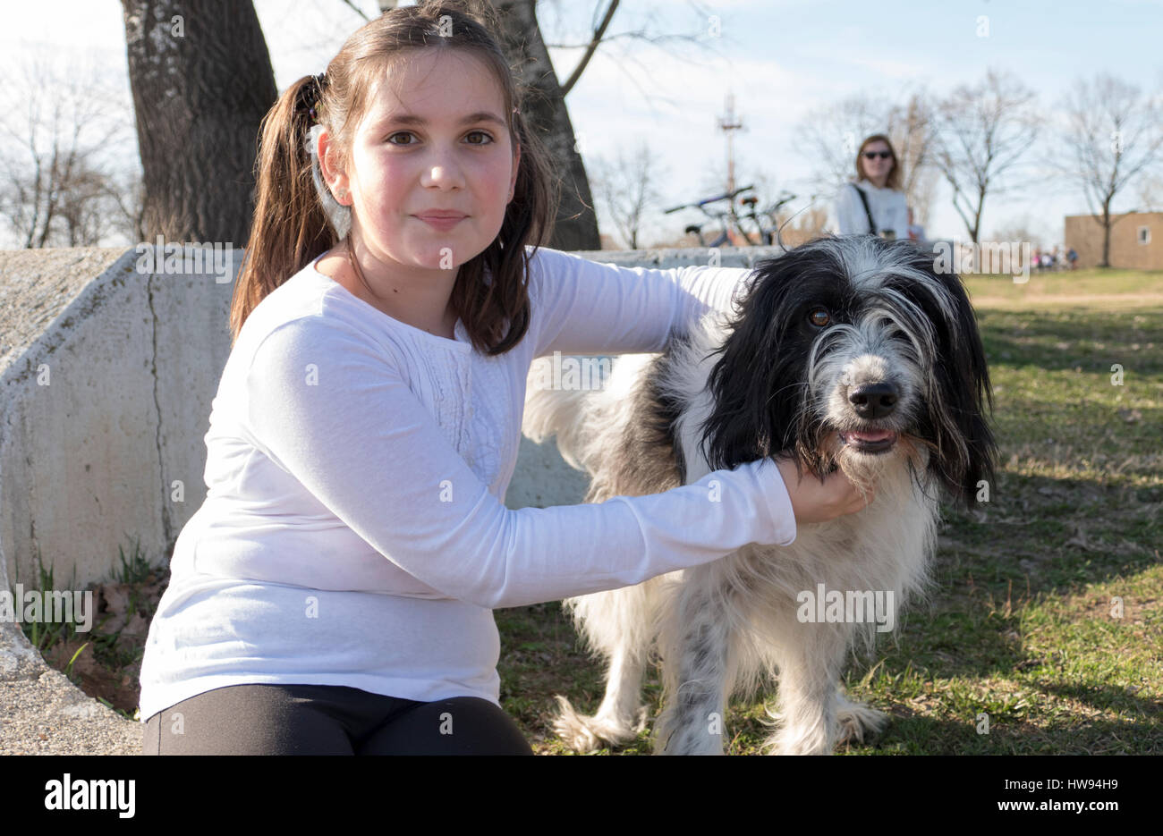Little girl with dog in park Stock Photo - Alamy