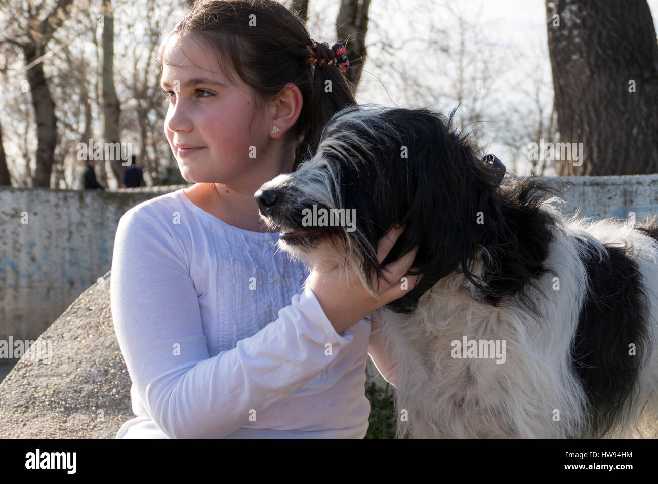 Little girl with dog in park Stock Photo - Alamy