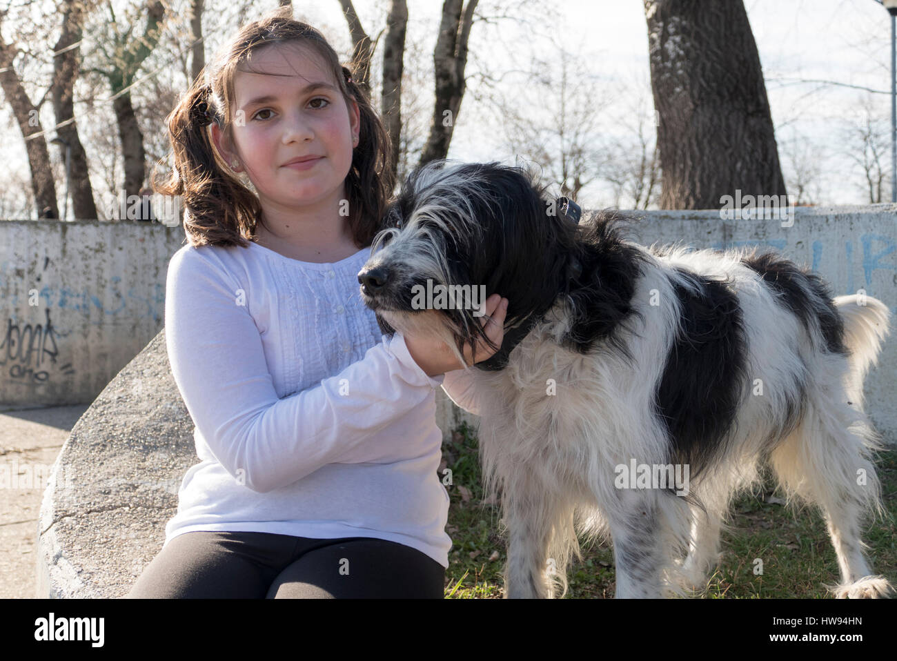 Little girl with dog in park Stock Photo - Alamy