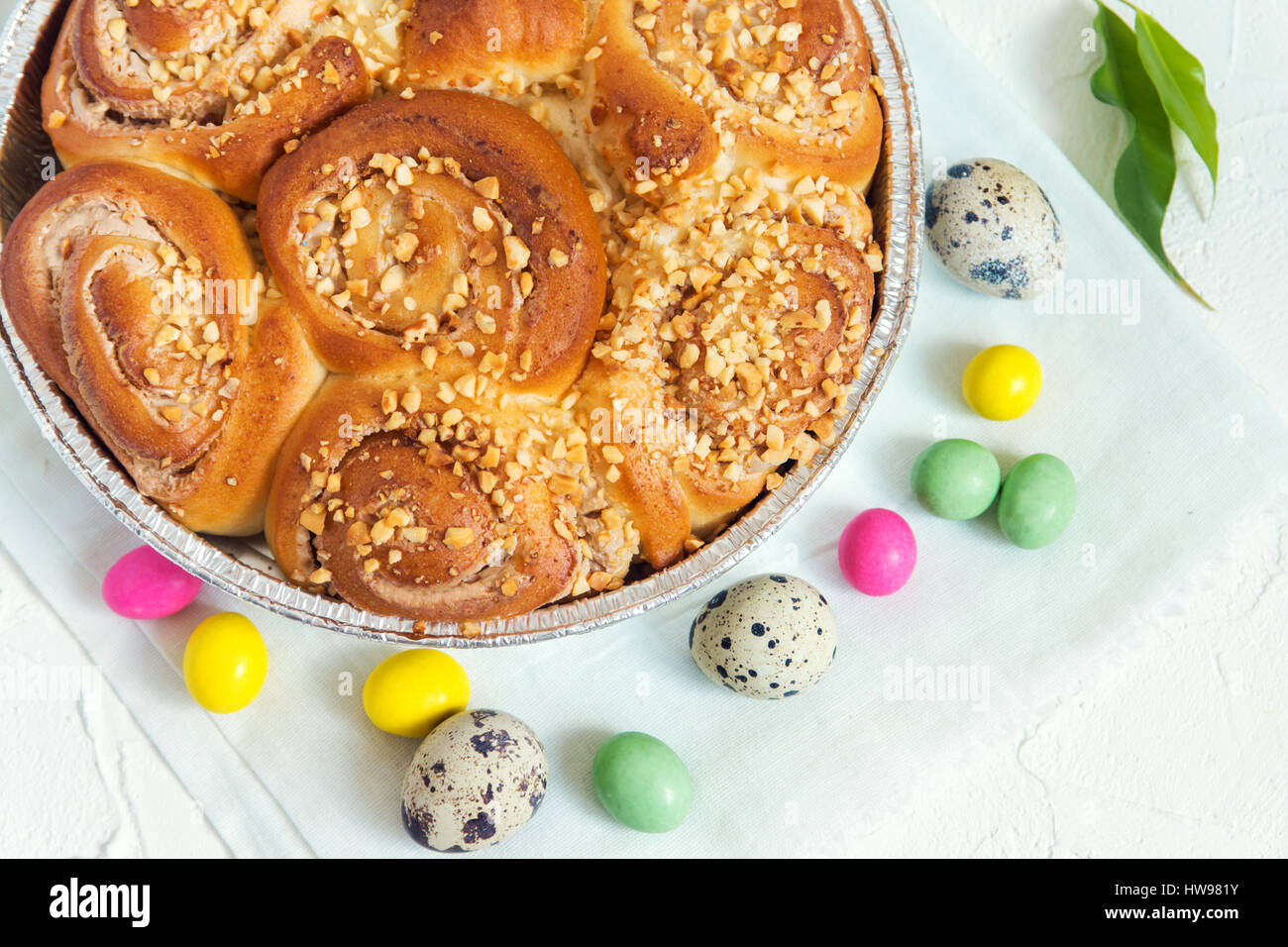 Easter pastry. Fresh Homemade Creamy Cinnamon Buns with Nuts. Cinnamon Rolls with Cream Cheese