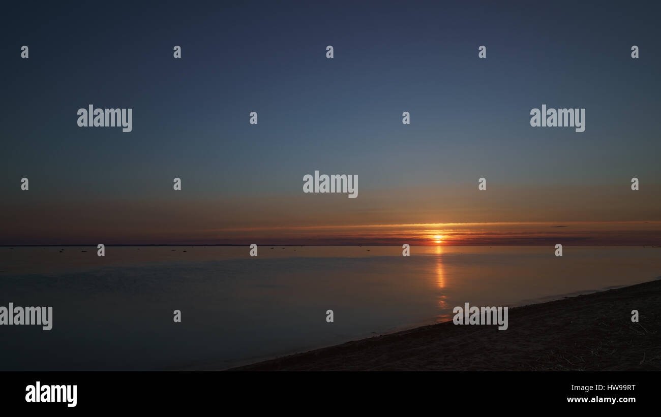 Sun with dark clouds over the baltic sea hi-res stock photography and ...
