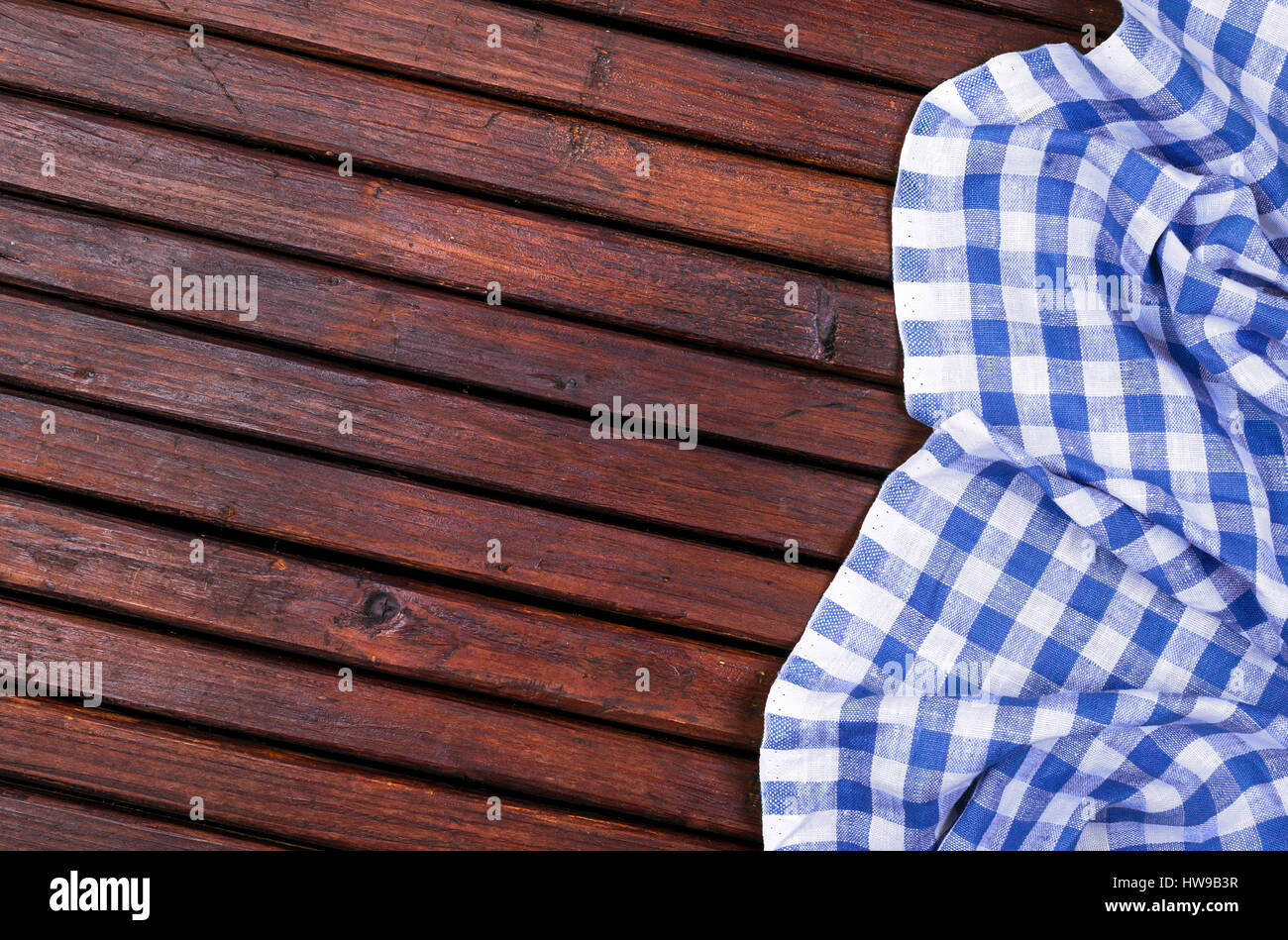 Dark wooden table with blue checkered tablecloth, top view with copy space Stock Photo