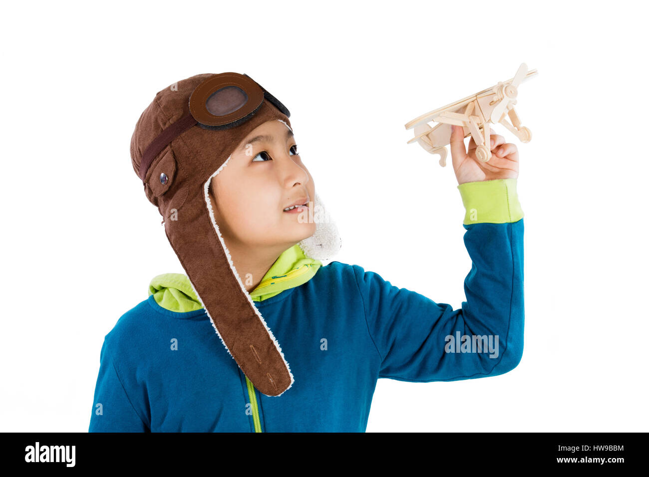 Asian Chinese Boy Playing with Wooden Airplane in isolated White Background Stock Photo