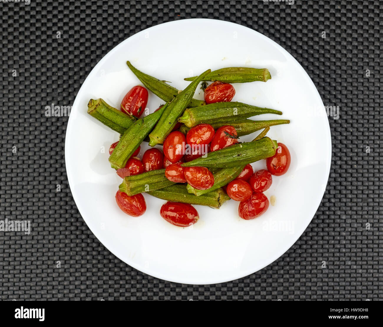 Okra cooked with red tomatoes and garlic Stock Photo Alamy