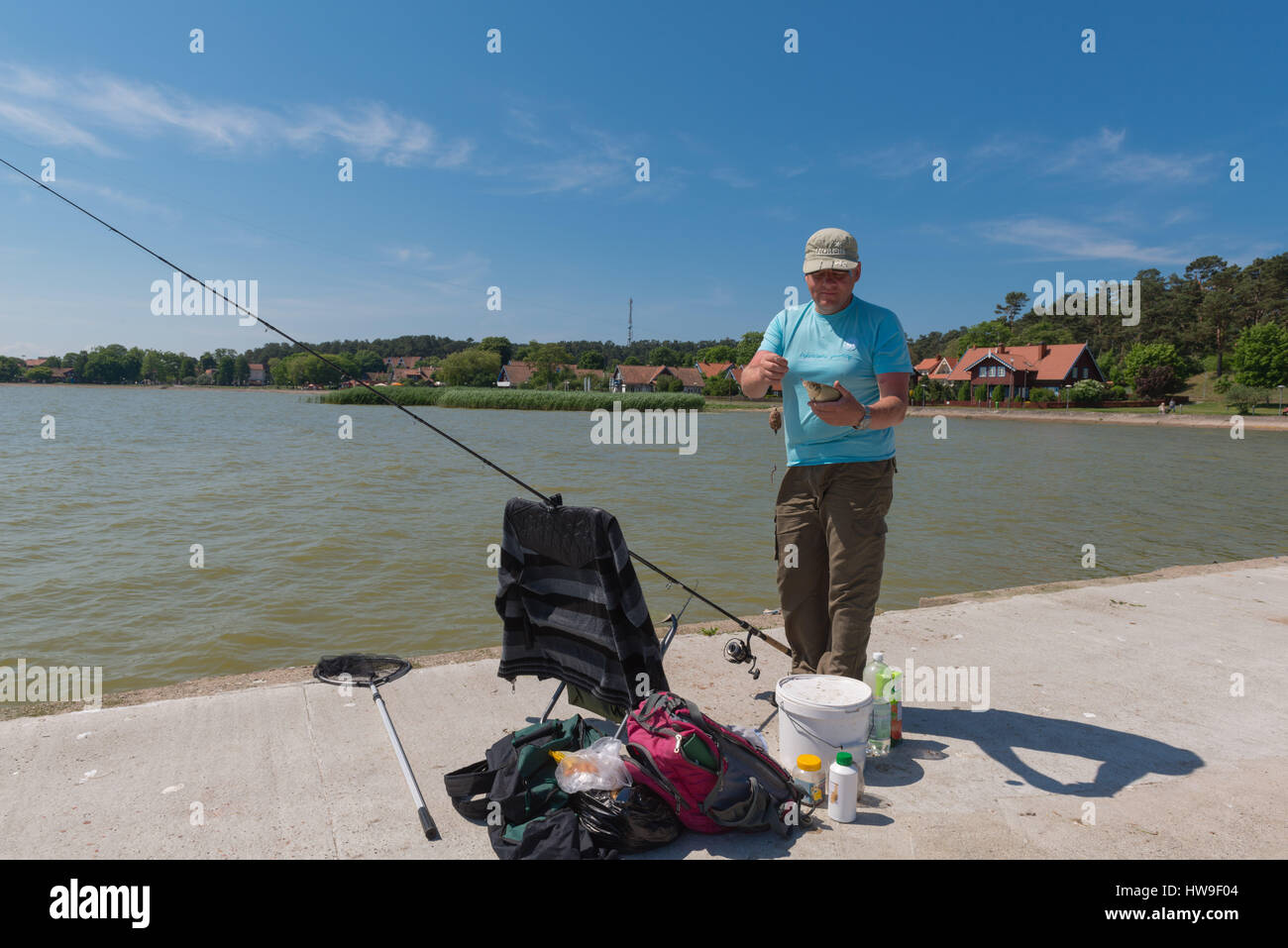 Hobby fisherman has caught a fish, Nida, Coronian Spit, UNESCO World Heritage, Lithuania, Eastern Europe Stock Photo