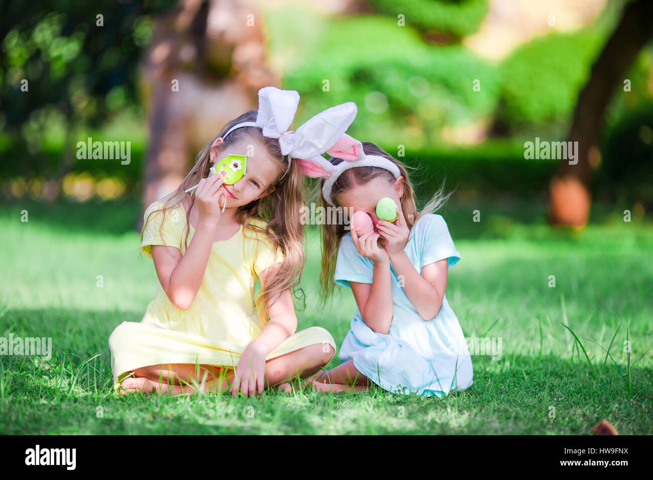 Adorable girl wearing bunny ears holding basket with Easter eggs Stock ...