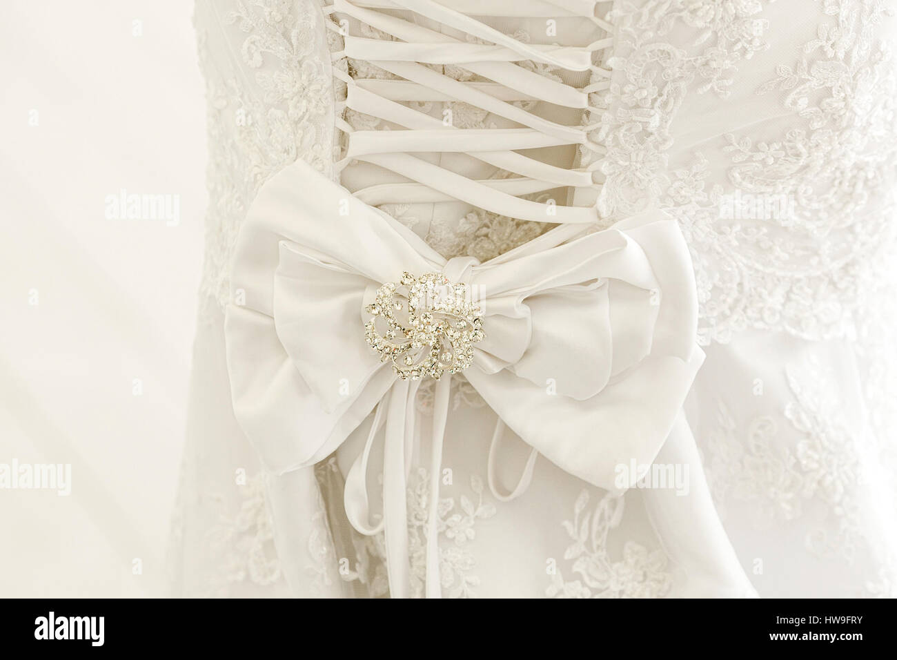 A close up of a wedding dress with a large silk bow Stock Photo
