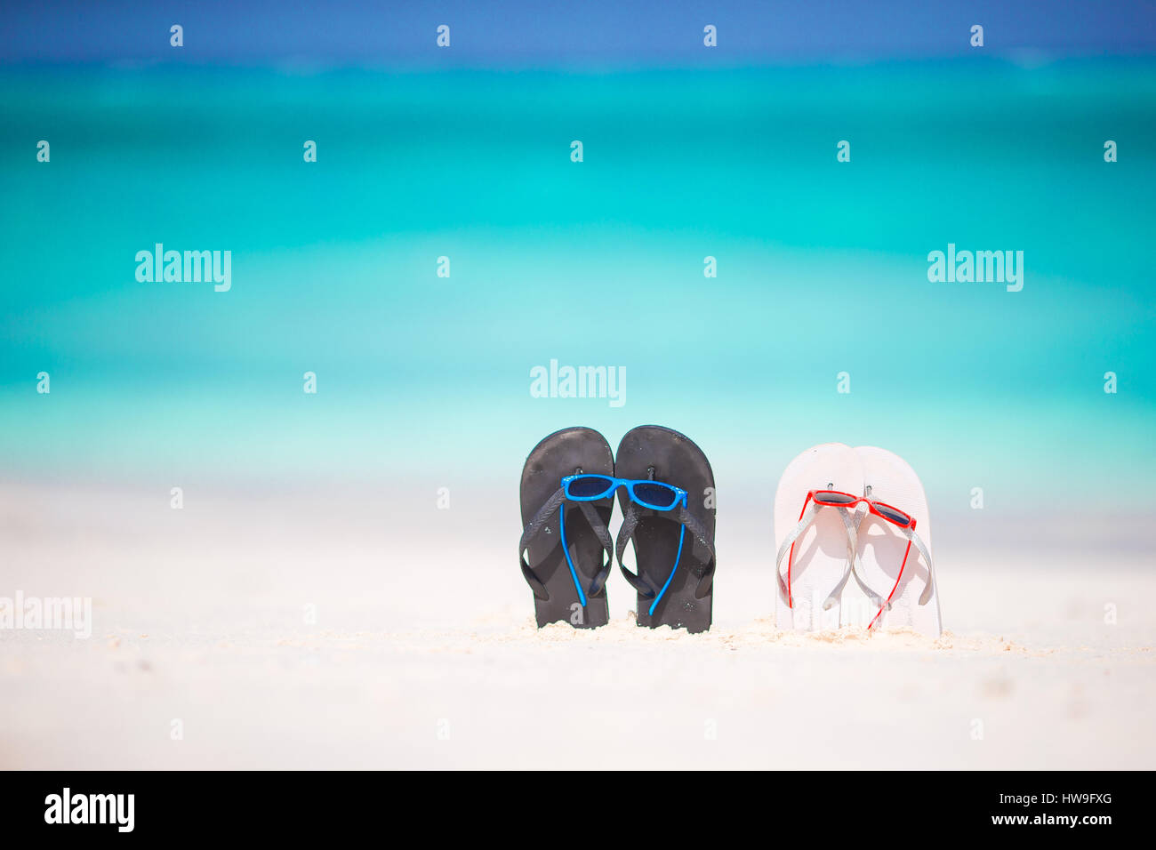 Summer flip flops with sunglasses on white beach Stock Photo - Alamy