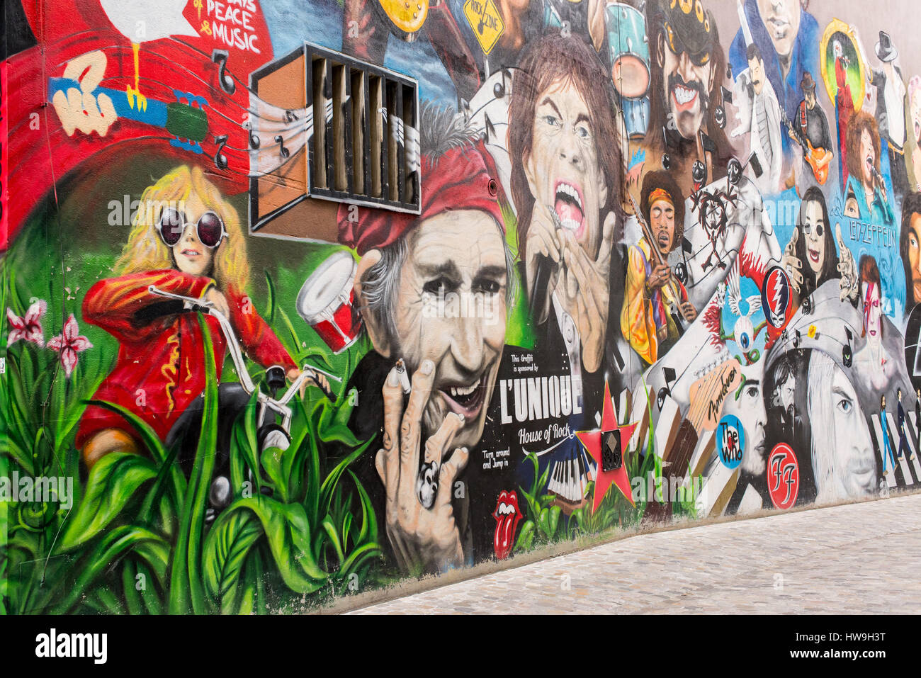 The wall shows portraits of rock stars like Janis Joplin, Keith Richard, Mick Jagger, Morrison and the Doors, Jimy Hendrix, The Who, Pearl Jam, Dave G Stock Photo