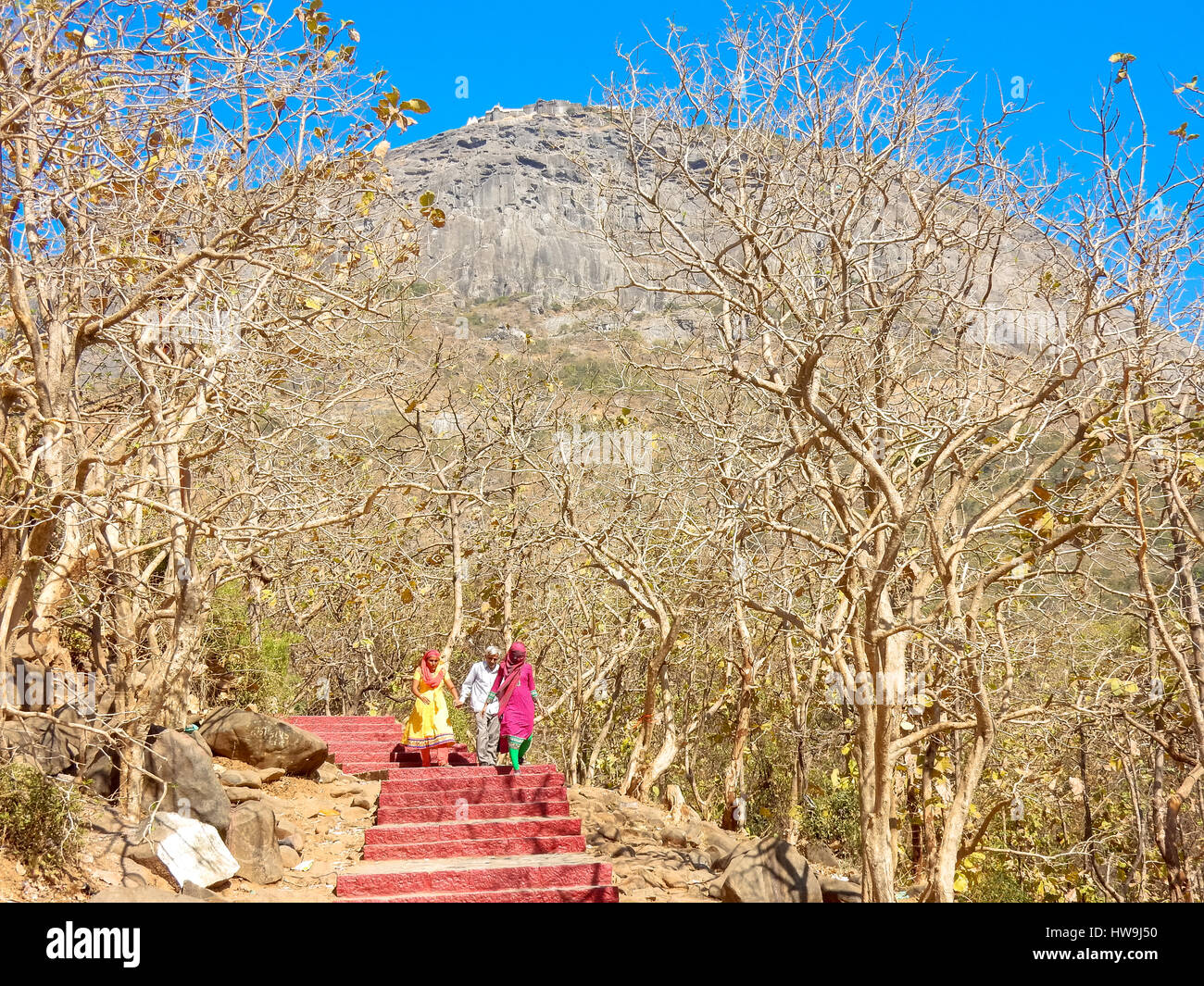 people on steps with mountain in the back at junagadh, india Stock Photo