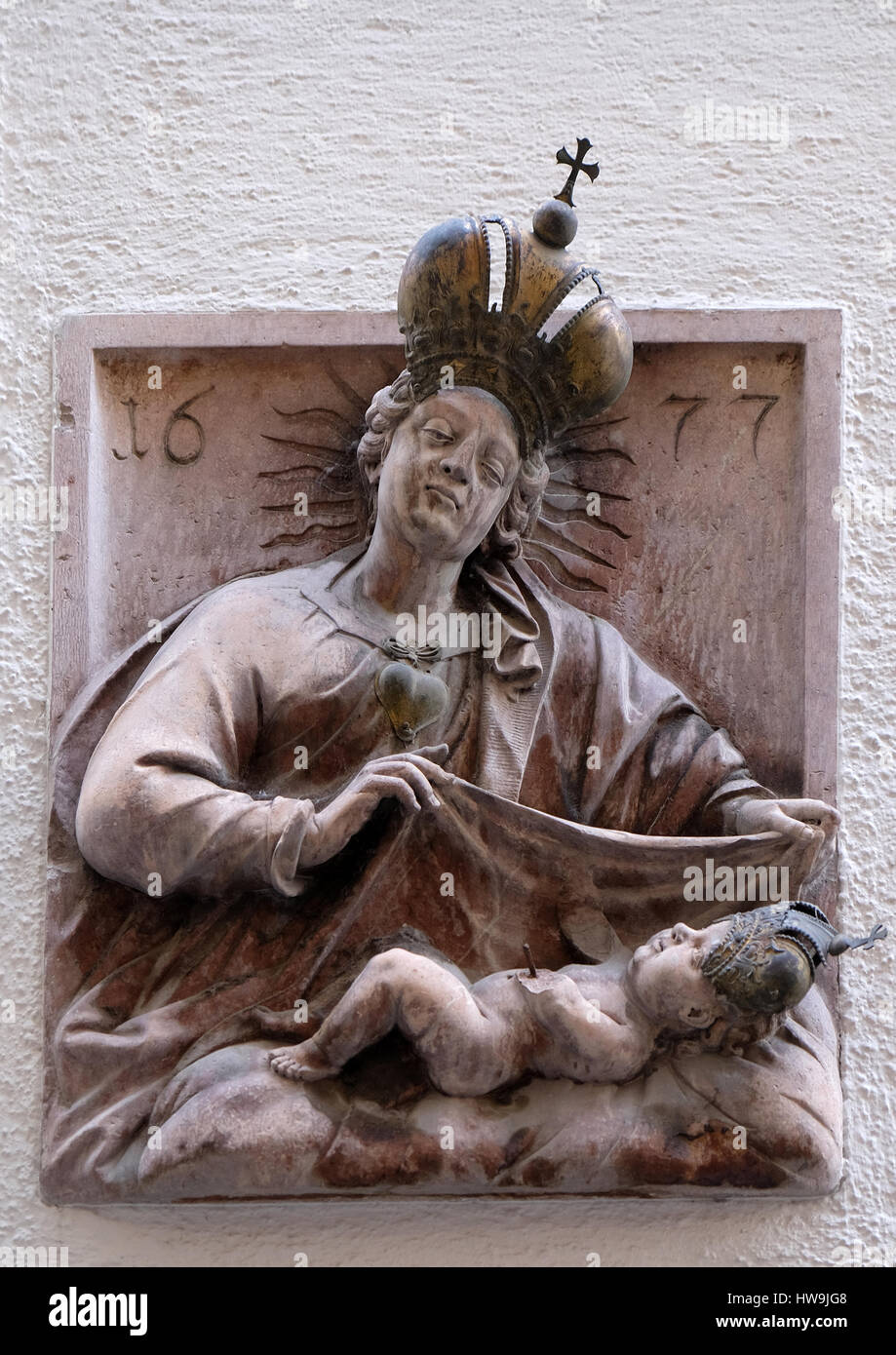 Virgin Mary with baby Jesus, statue on house facade Salzburg, Austria ...