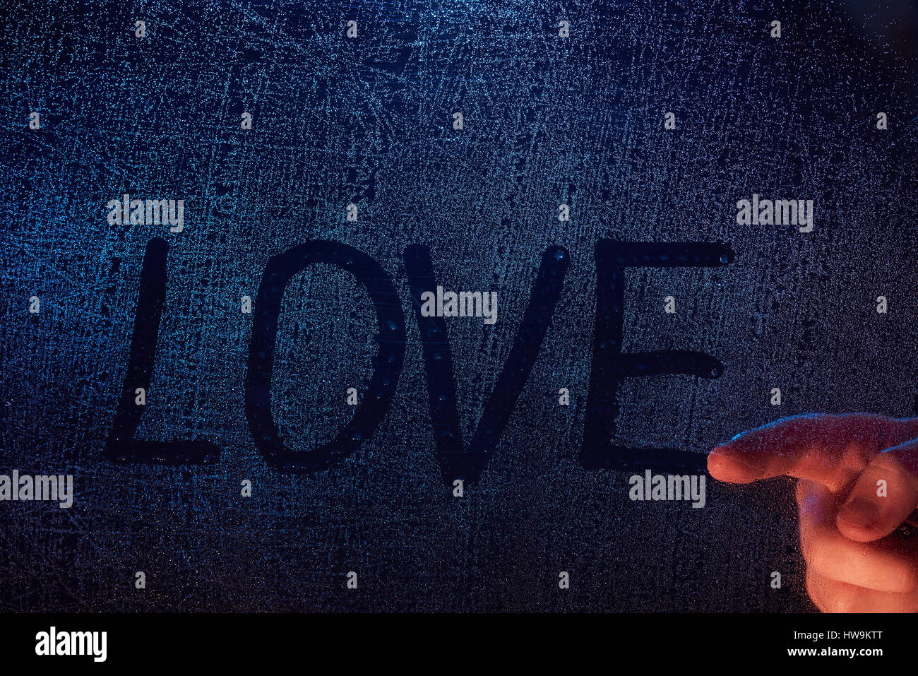 Hand draw love word on frozen glass window background. Love word concept Stock Photo