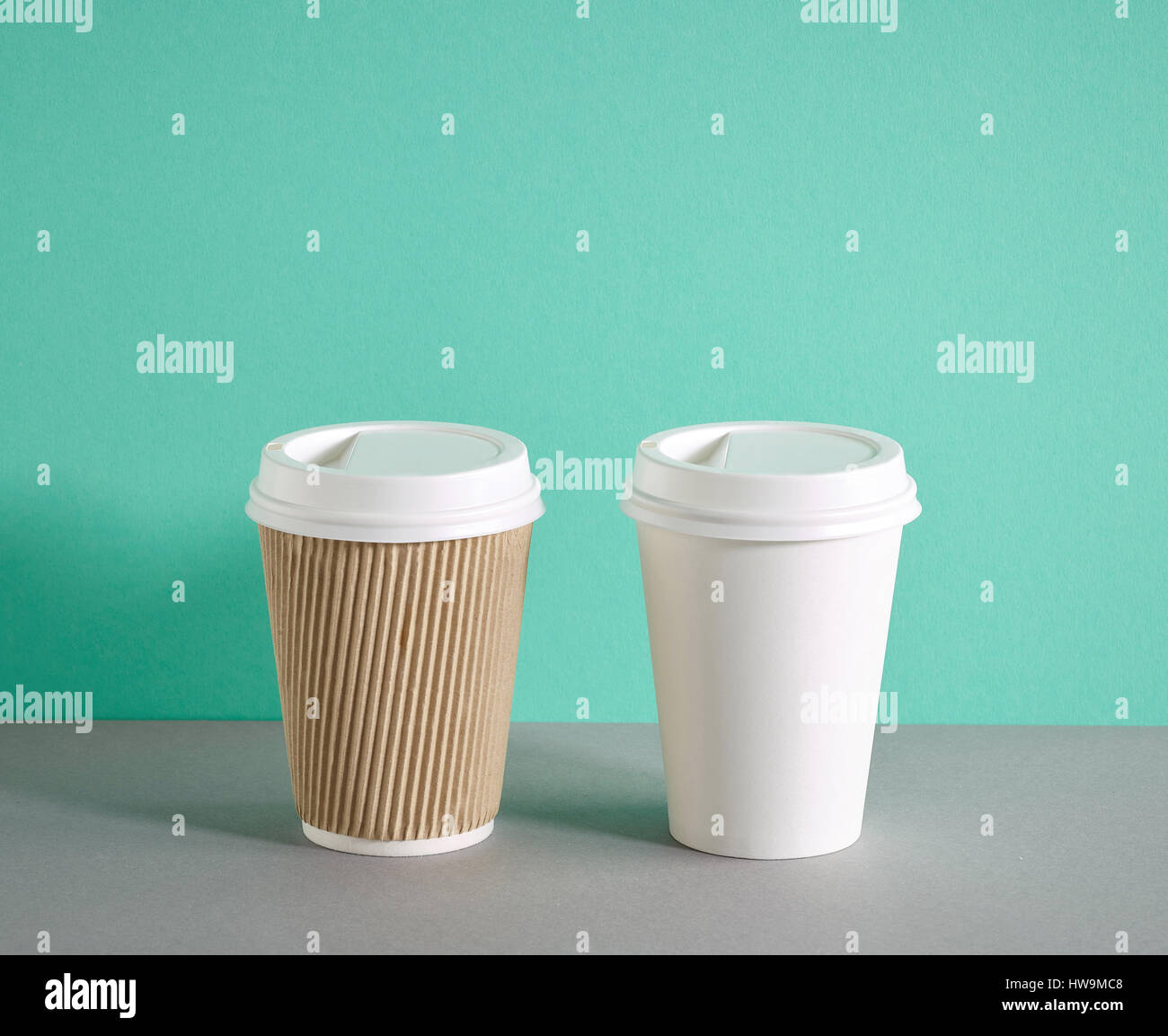two paper coffee cups on colorful background Stock Photo - Alamy