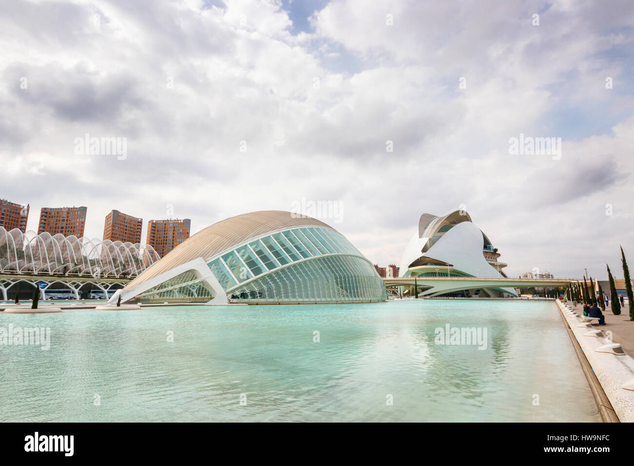L'Hemisferic, part of the City of Arts and Sciences, under a cloudy sky with Palau de les Arts Reina Sofia at the background. Valencia, Spain. Stock Photo
