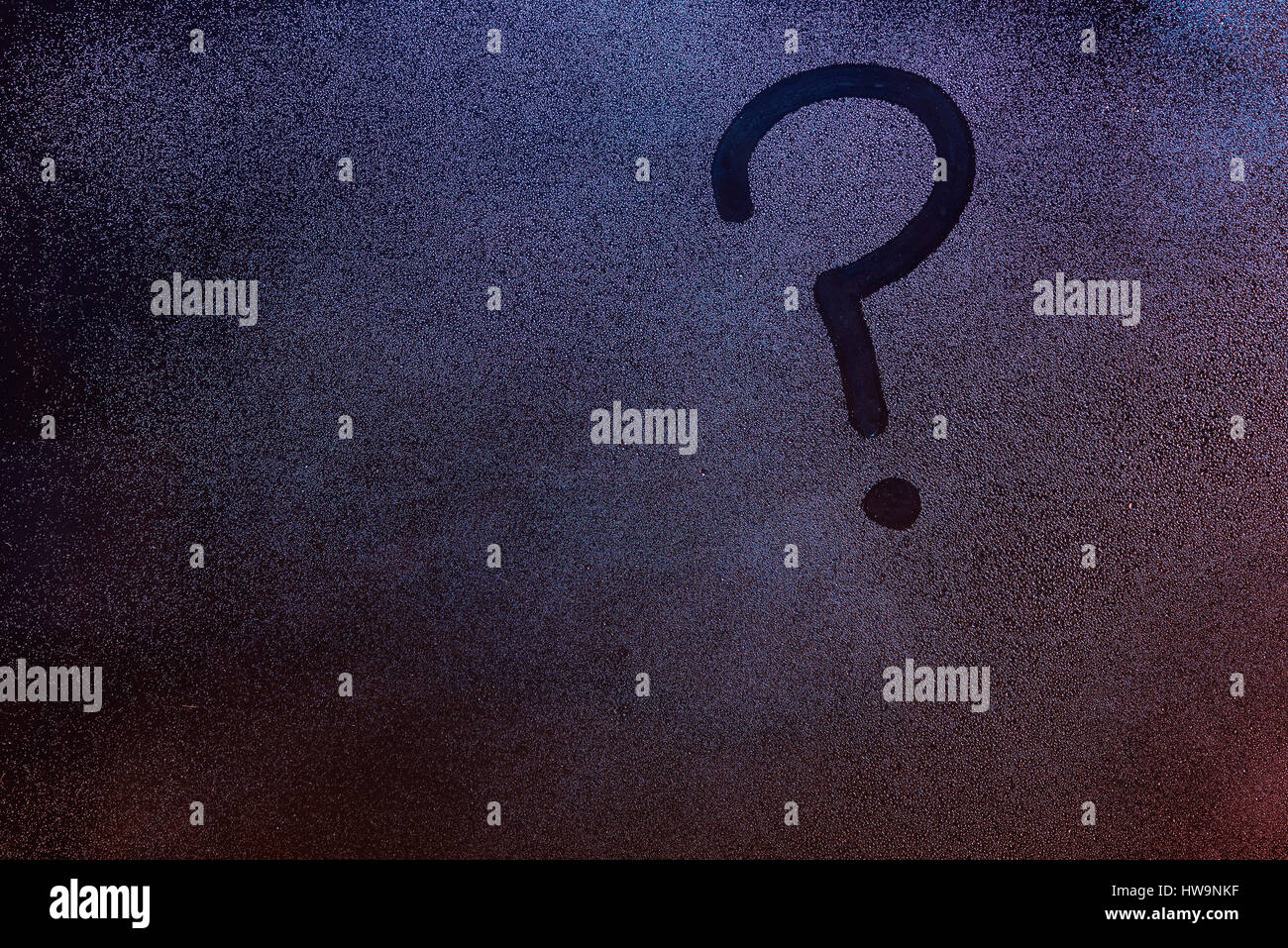 Question mark symbol on wet fogged window background. Ask sign on frozen window glass Stock Photo