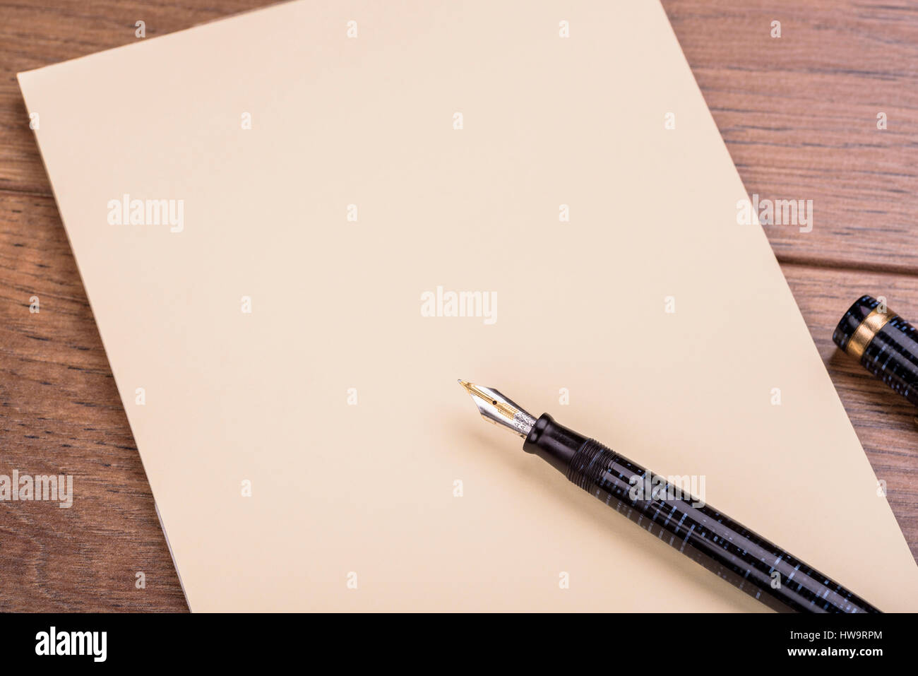 Fountain pen pad paper letter. Blank paper and pen shot from overhead. Stock Photo