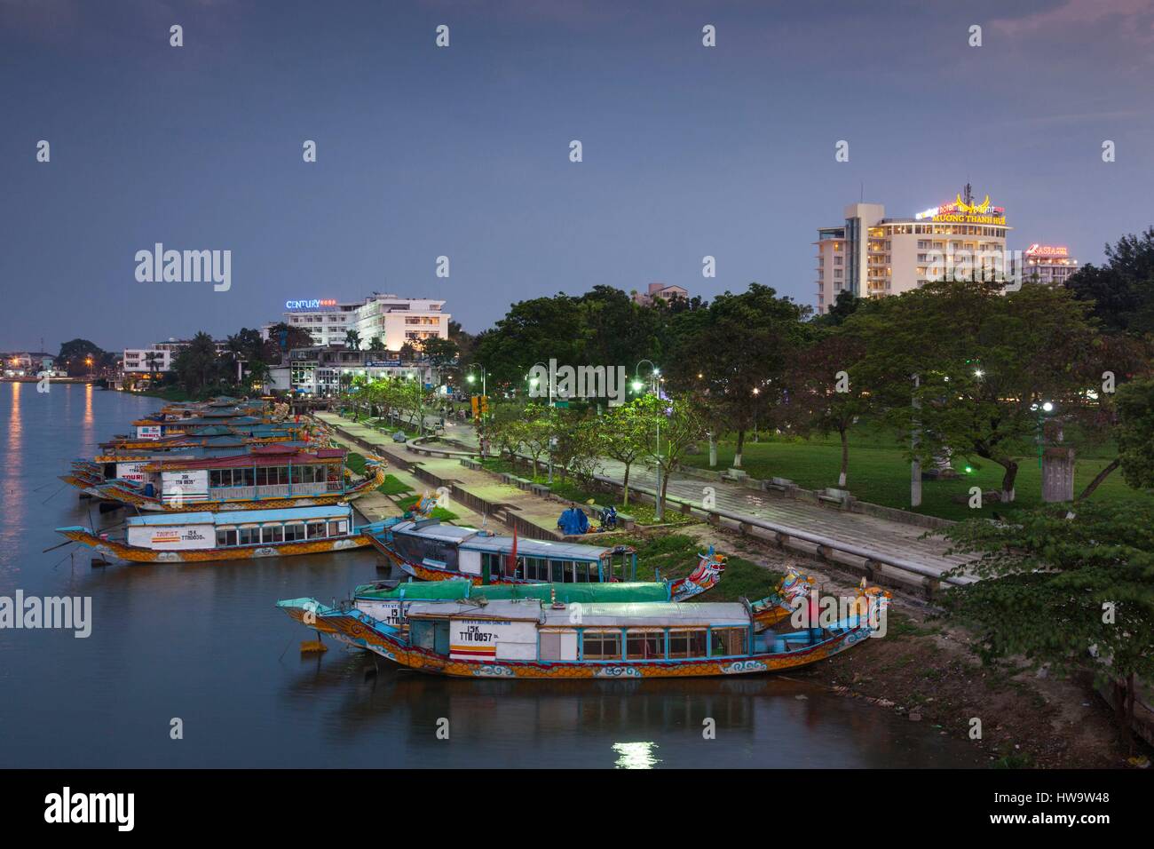 Vietnam, Hue, elevated view of Century Hotel, Perfume river and dragon boats, dusk Stock Photo