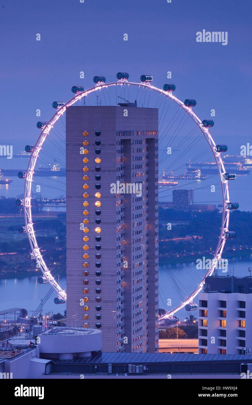 Singapore, Singapore Flyer, giant ferris wheel, elevated view with Ritz Carlton Hotel, dawn Stock Photo