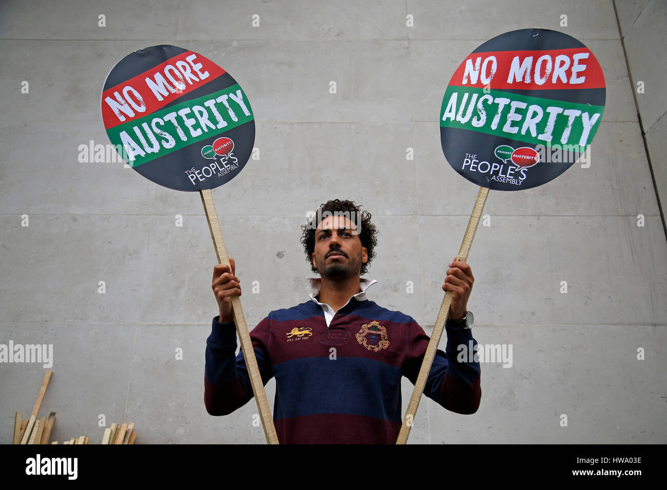 A man hold 'No More Austerity' placards during an anti austerity demonstration on London on 10 July, 2014. Stock Photo