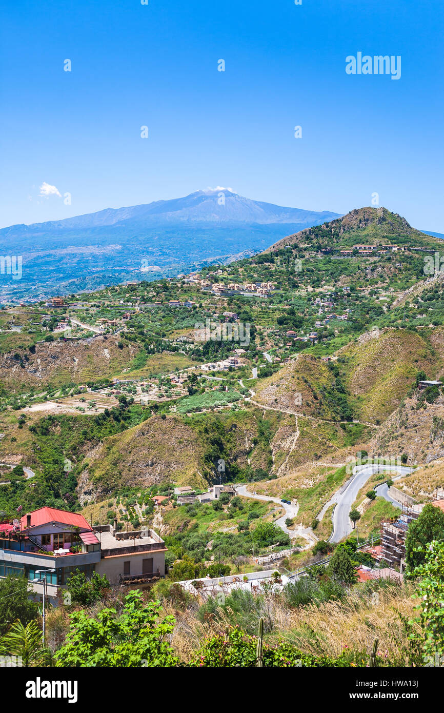 travel to Italy - green hills with villages and Etna volcano in Sicily Stock Photo