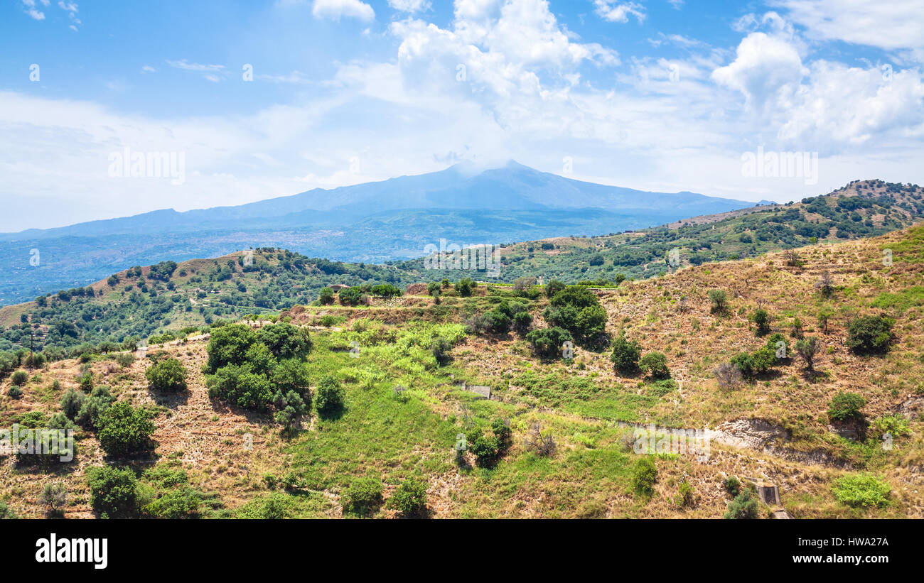 travel to Italy - view of Etna mount and green mountain slope near Calatabiano town in Sicily Stock Photo