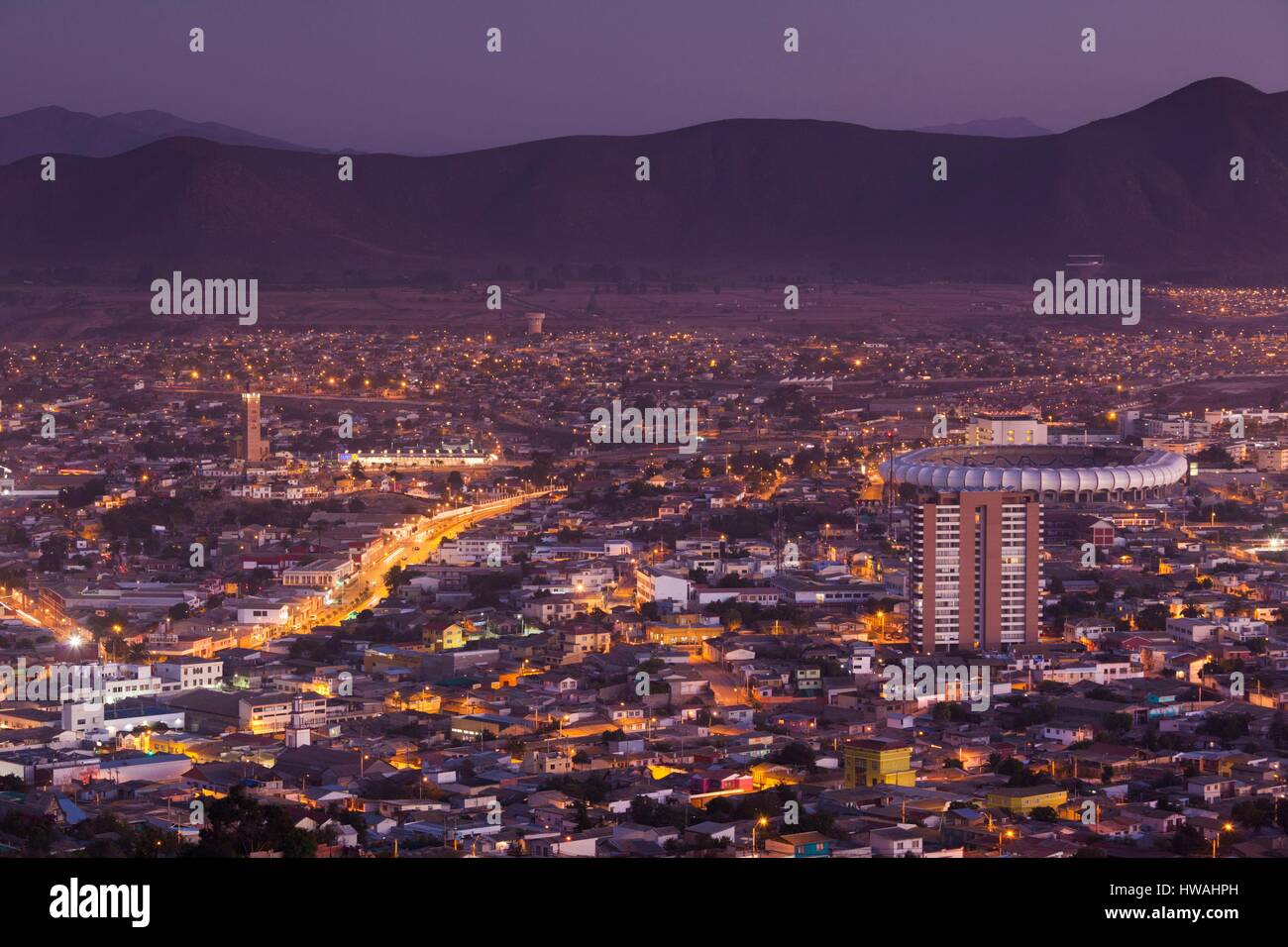 Chile, Coquimbo, elevated city view with Mohammed VI Cultural Center and Sanchez Romoroso Stadium from the Cruz del III Milenio cross, dusk Stock Photo