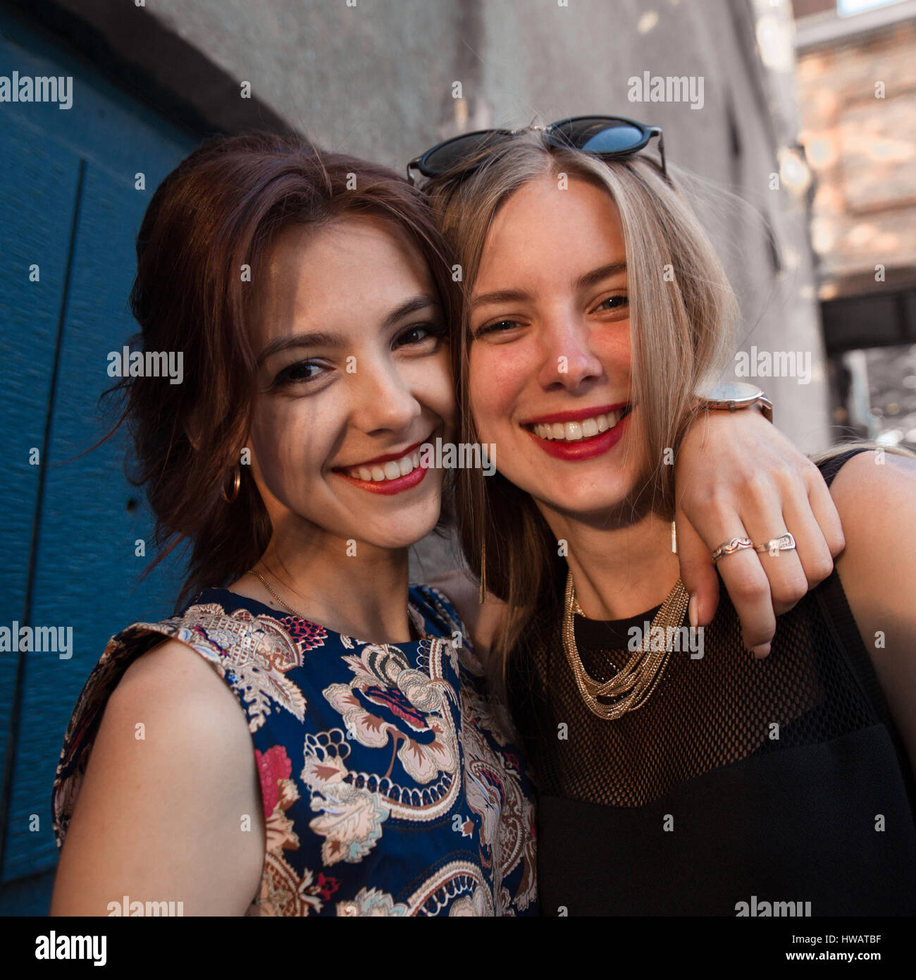Lifestyle cute portrait of two best friends sister girls, hugs , having fun and posing on camera, stylish clothes and accessorizes, natural makeup,par Stock Photo