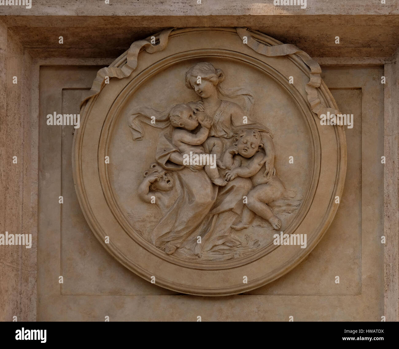 Charity Medallion on the Palazzo Montecitorio, seat of the Italian Chamber of Deputies in Rome, Italy Stock Photo