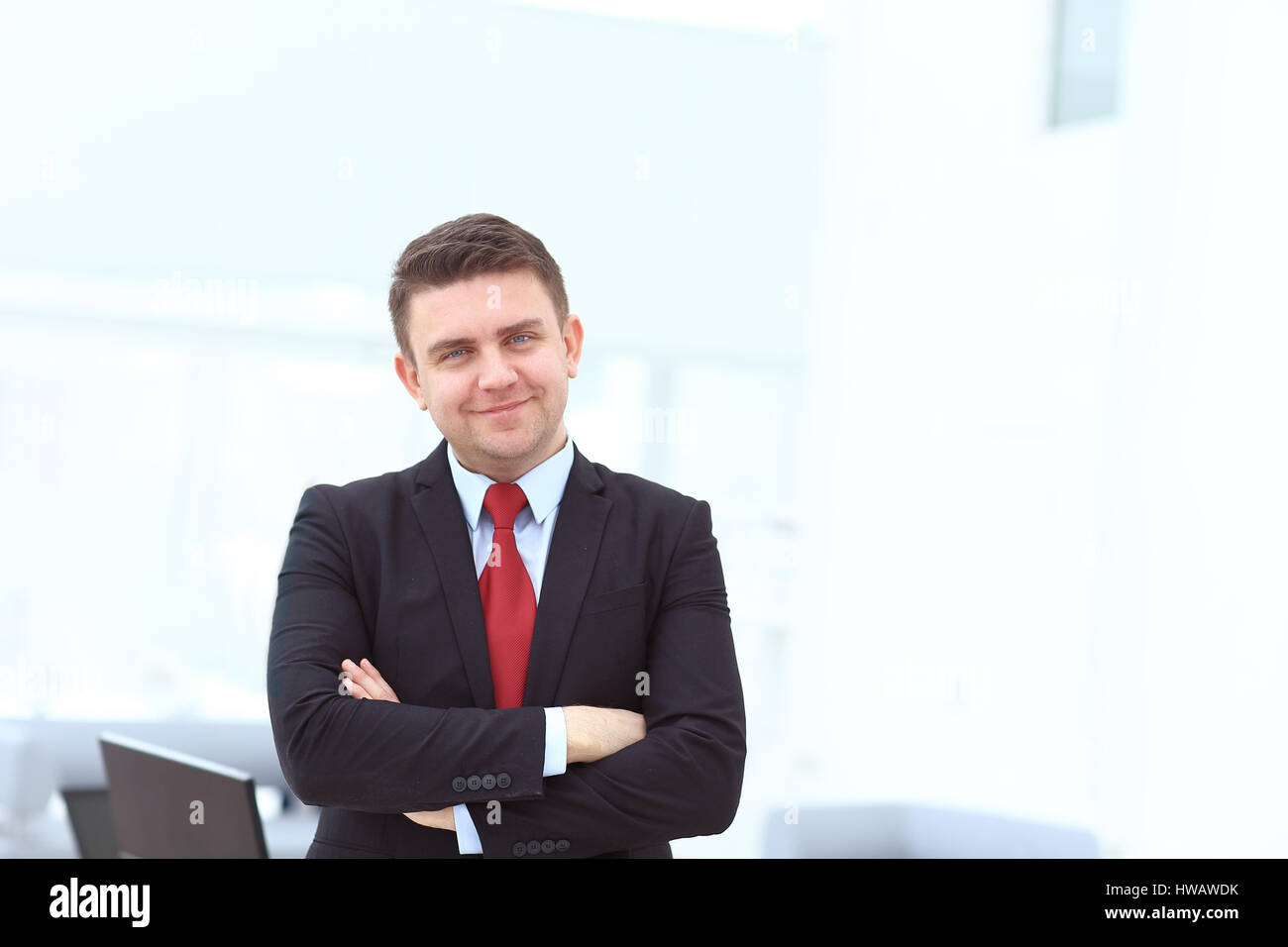 Successful businessman posing with crossed arms smiling Stock Photo - Alamy