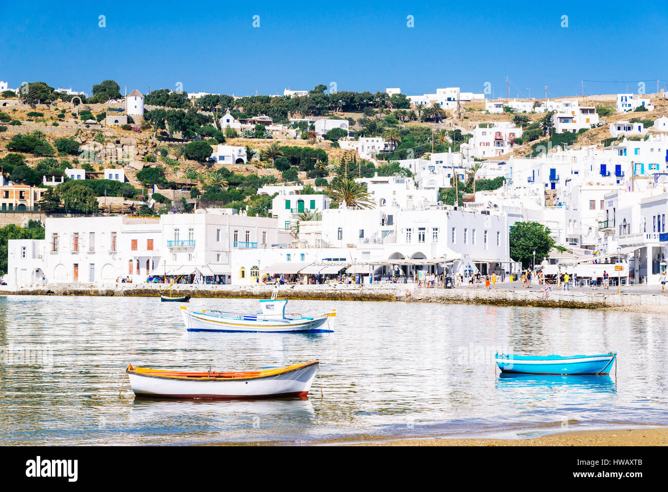 Mykonos harbor and reflections of the whitewashed town in the aegean sea, Mykonos island, Cyclades, Greece Stock Photo