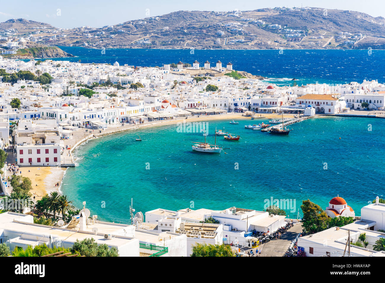 Panoramic view of the Mykonos town harbor from the above hills on a sunny summer day, Mykonos, Cyclades, Greece Stock Photo