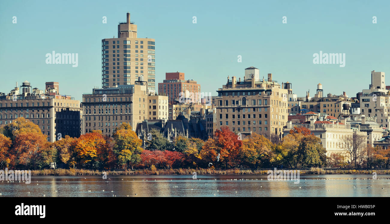 Central park Manhattan east side luxury building over lake in Autumn in New York City. Stock Photo