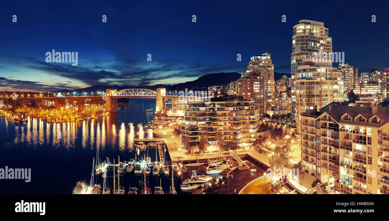 Vancouver harbor view with urban apartment buildings and bay boat at